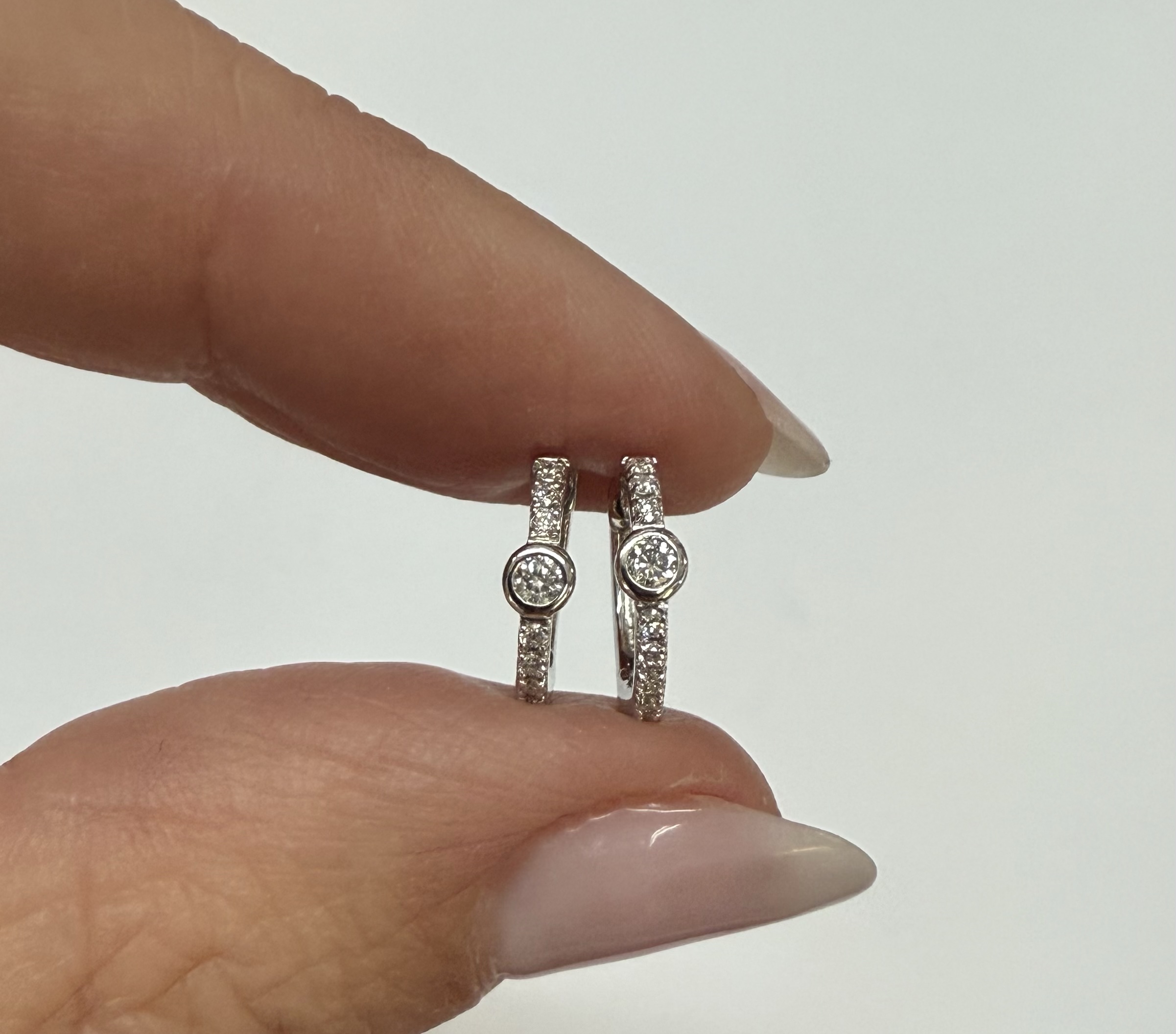 14k White Gold Bezel Set Genuine Diamond .12 Cttw Huggy Hoop Earrings - Image 2