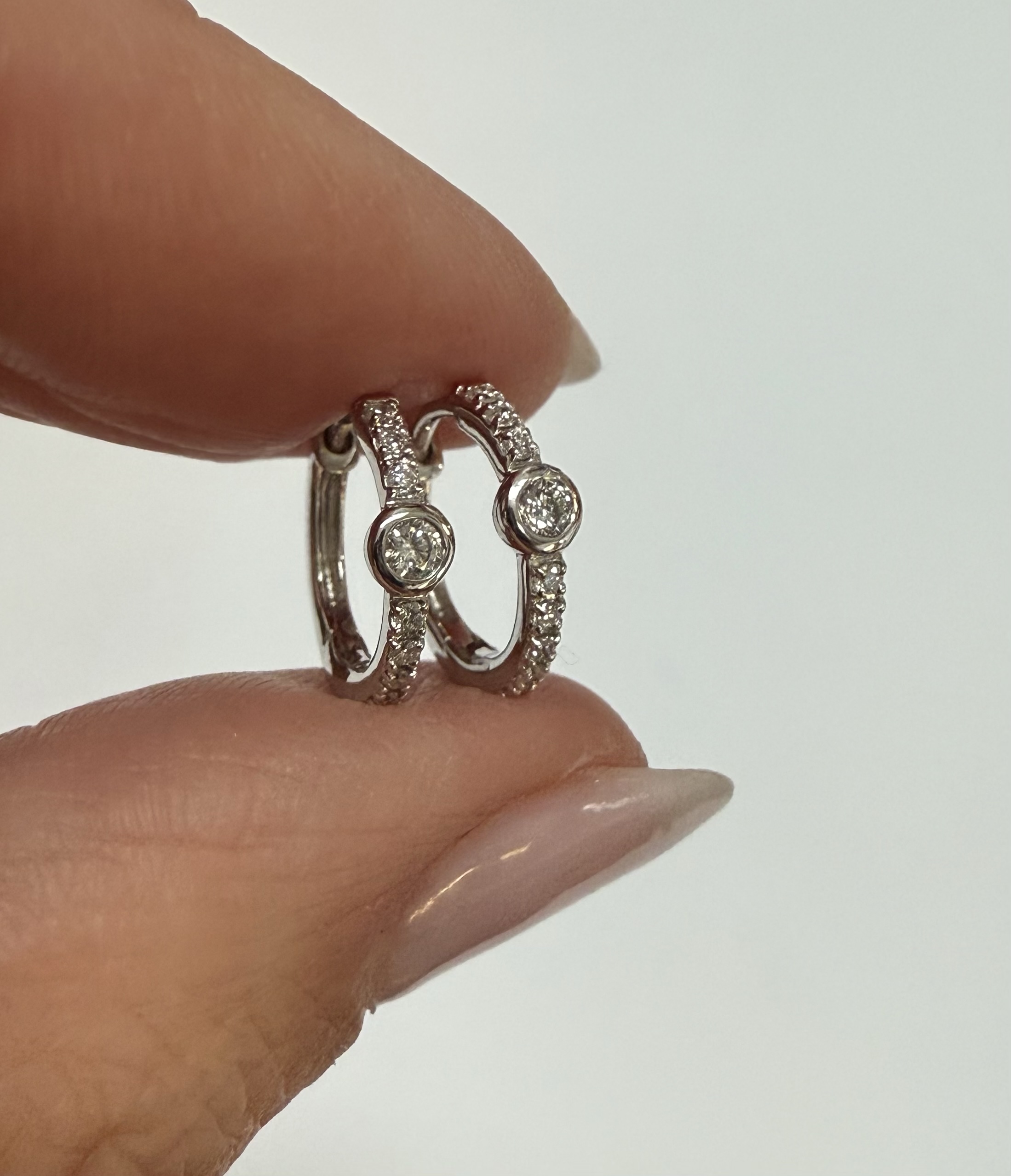 14k White Gold Bezel Set Genuine Diamond .12 Cttw Huggy Hoop Earrings - Image 3