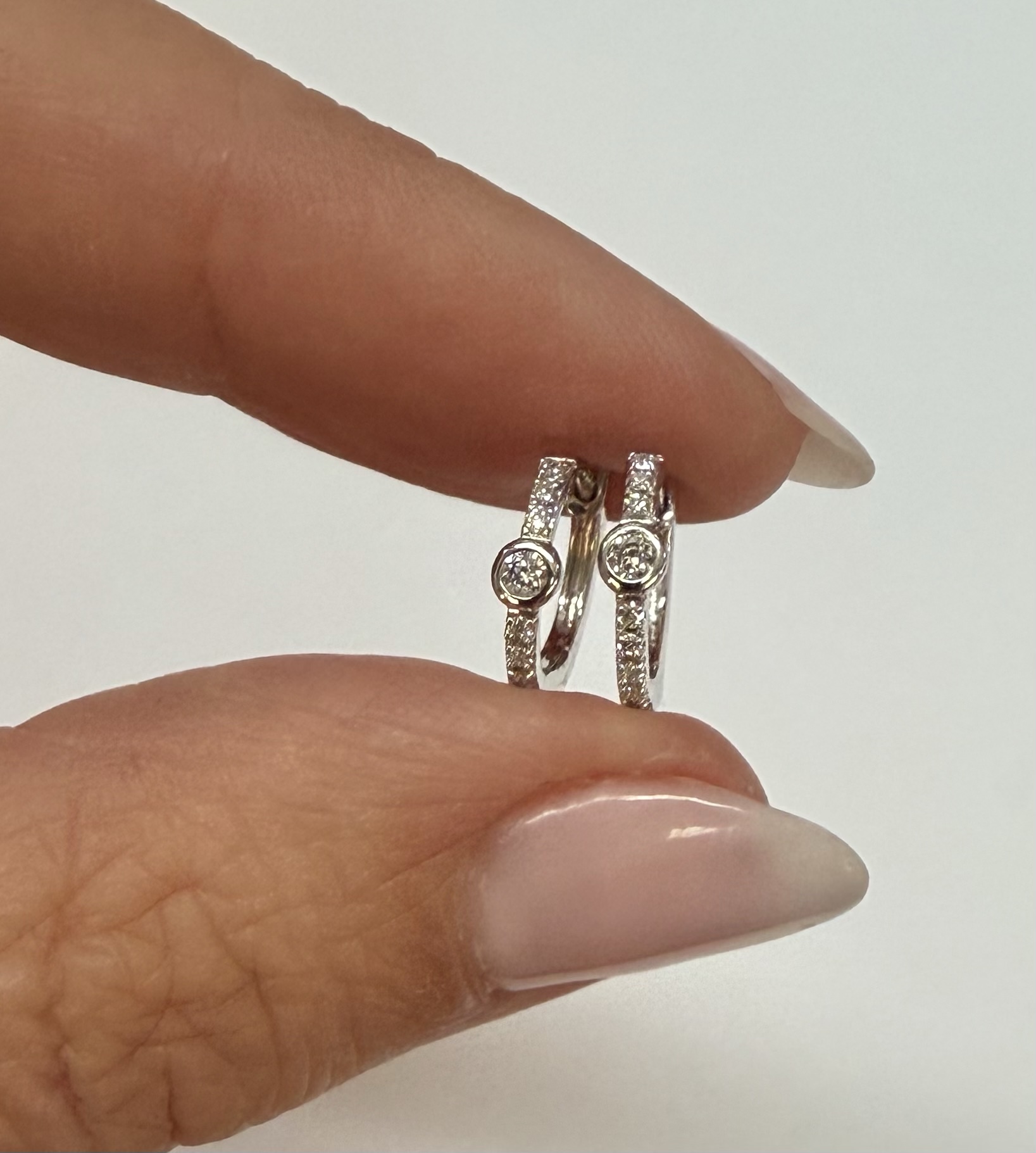 14k White Gold Bezel Set Genuine Diamond .12 Cttw Huggy Hoop Earrings - Image 5